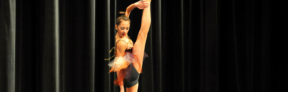 A picture of a dancer extending her leg